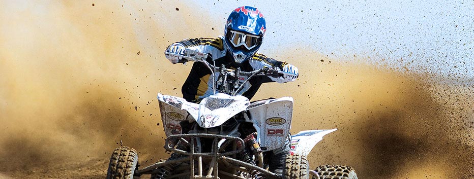 Man Riding ATV in Dirt with Helmet