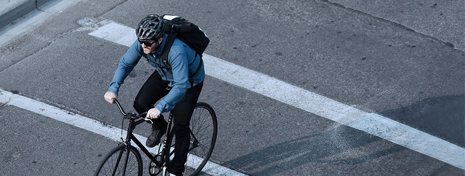 Man riding bicycle to work wearing helmet