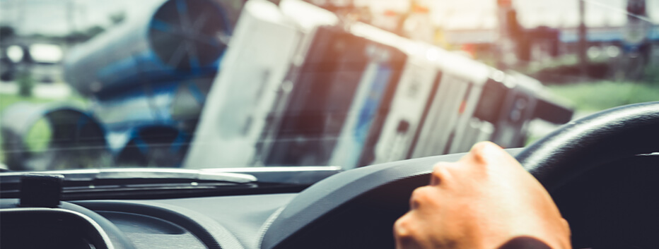 Man driving car witnessing truck accident