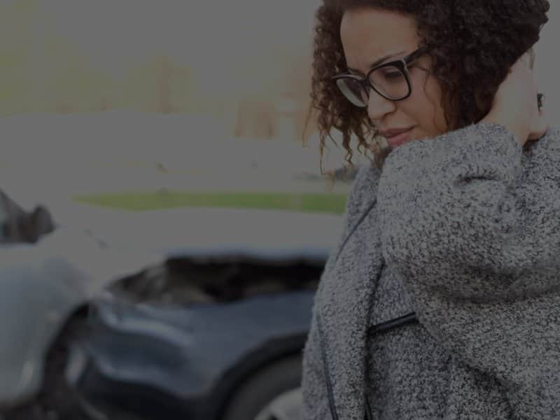 Woman holding her neck after a car crash