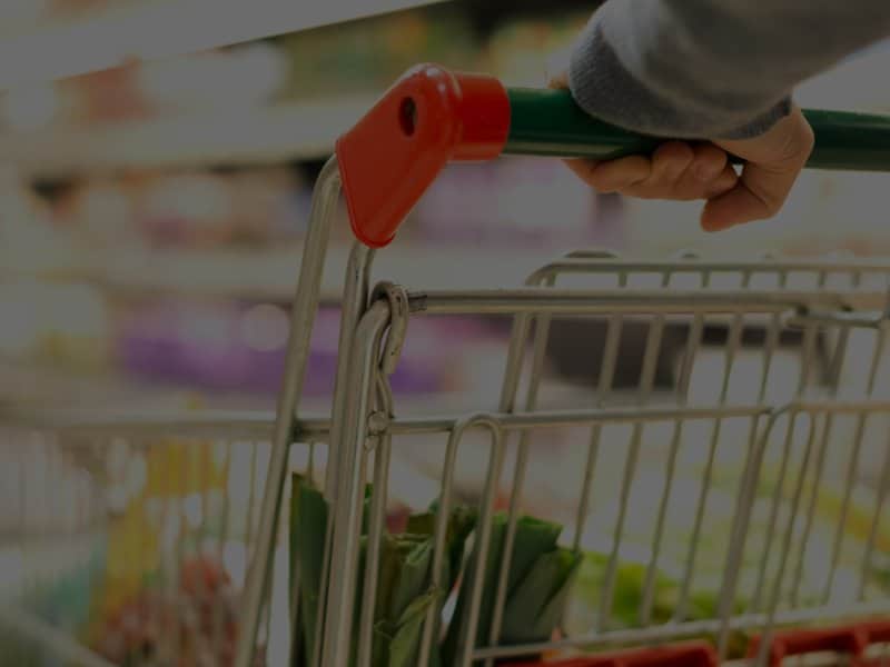 Woman pushing grocery cart in market